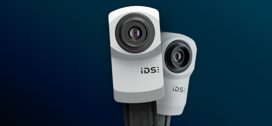 Deux caméras industrielles IDS uEye XC sur fond bleu.
