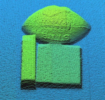 Nuage de points d’un objet à surface granuleuse avec un environnement bleu.