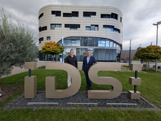 Le lauréat Jonas Gaißer et le professeur Heiko Thimm devant le bâtiment de l'entreprise IDS