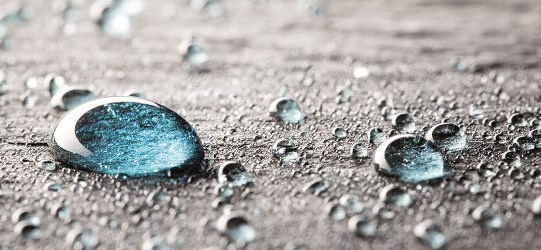 Goutte d'eau en gros plan. Symbole d'une boîte avec des flèches.