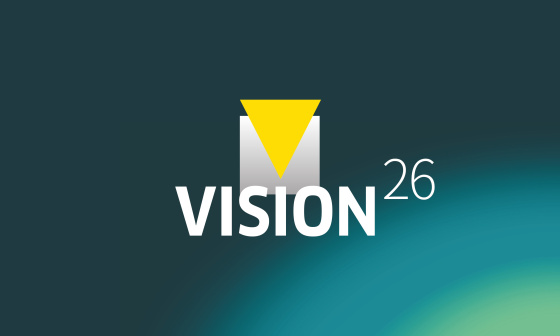 Graphisme avec l'inscription « VISION26 » sur fond bleu-vert.